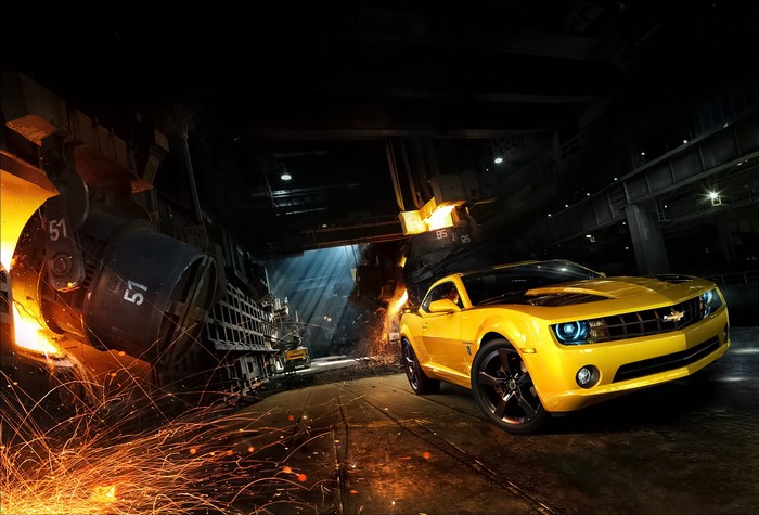 Yellow Chevrolet Camaro SS in industrial setting