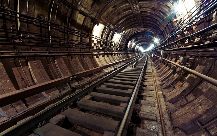 Subway tunnel with railway tracks and lights