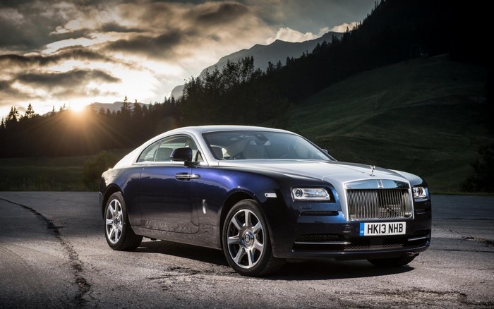 Rolls-Royce Wraith parked on a road with mountains