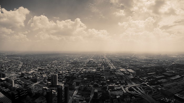 Sepia toned aerial view of Chicago cityscape with clouds