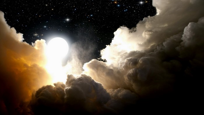 Moon and stars in a cloudy night sky