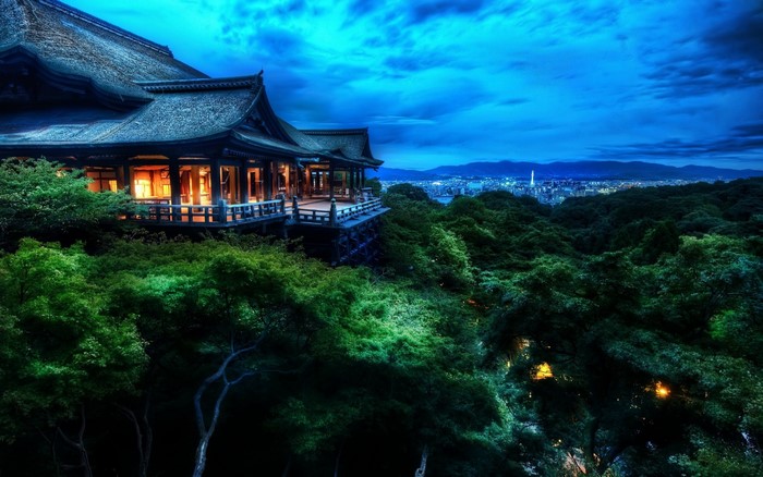 Japanese temple overlooking a city at dusk