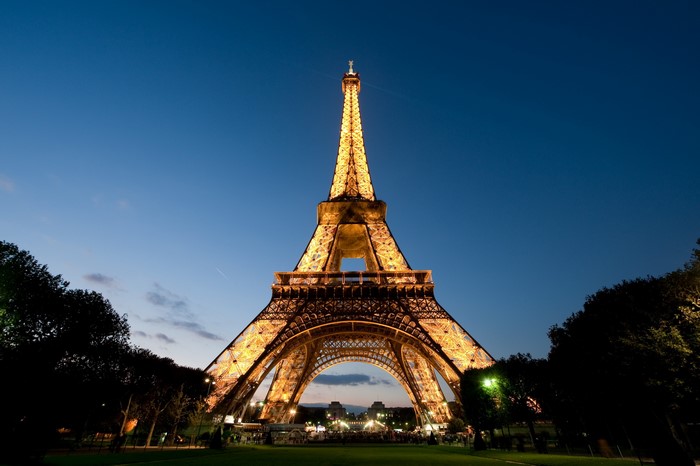 Eiffel Tower illuminated at dusk in Paris, France