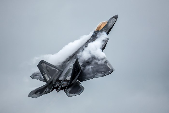 F-22 Raptor performing a maneuver with smoke