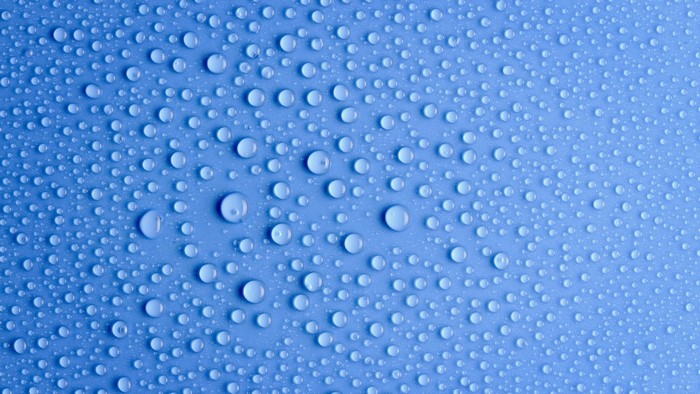 Water drops on a blue surface