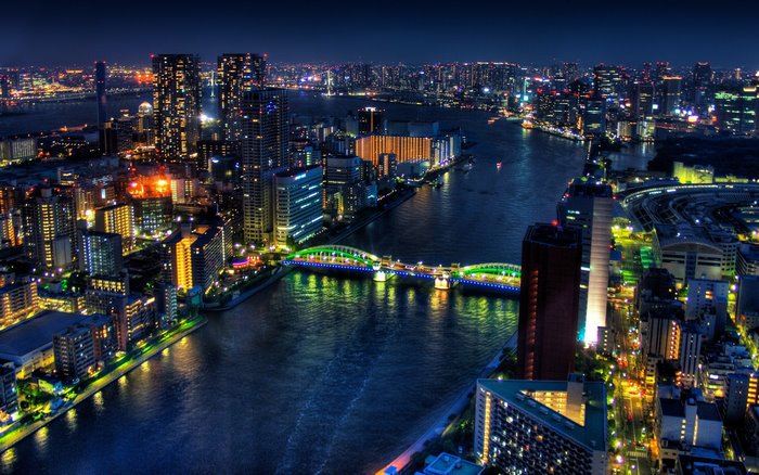 Night cityscape of Tokyo with illuminated bridge over river