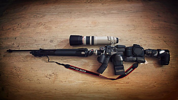 Canon camera and lens assembled as a rifle on a tripod
