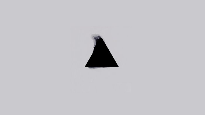 Black triangle with smoke on gray background