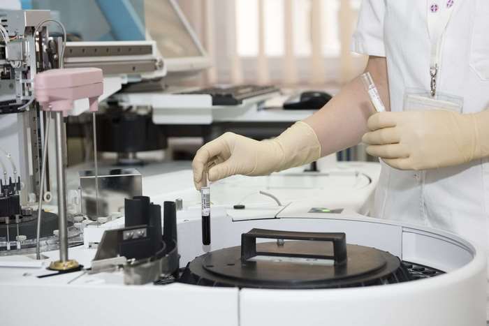 Medical professional working with laboratory equipment