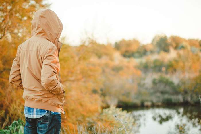 Person in a jacket in autumn landscape 4K