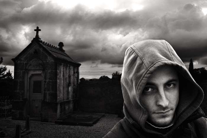 Man in Hood in Cemetery