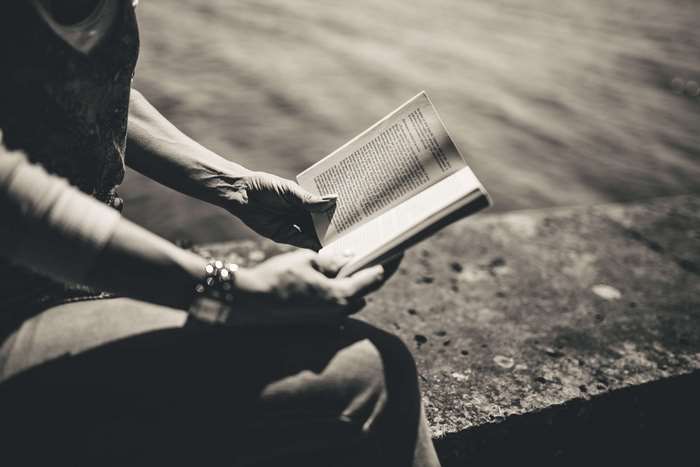 Woman reading a book outdoors