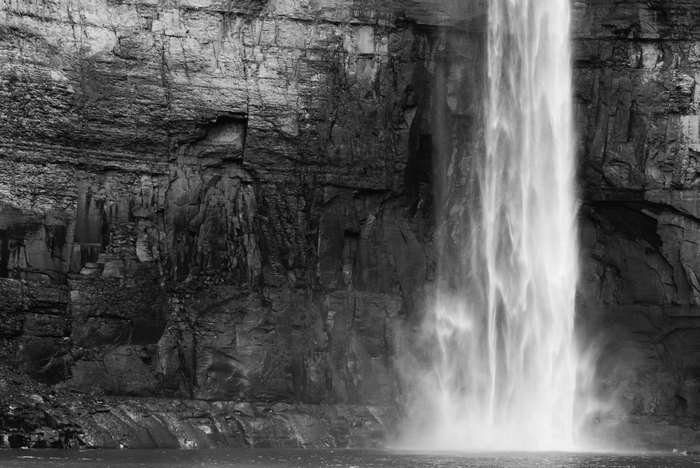 Black and white waterfall cascading down a rocky cliff
