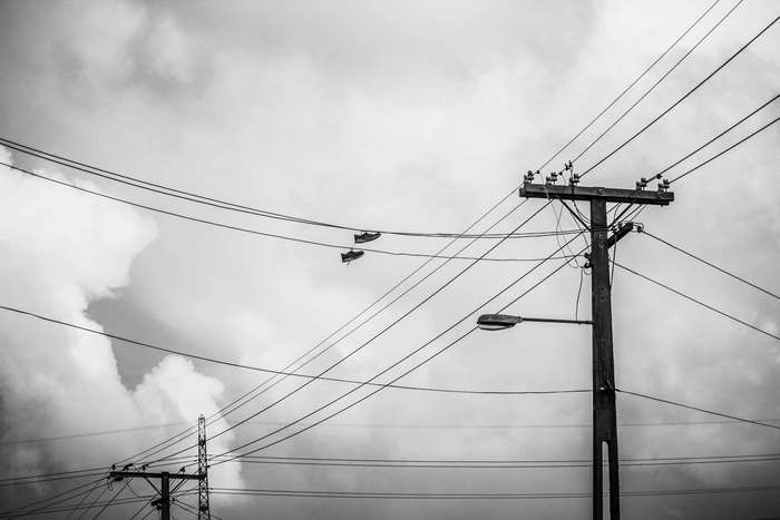 Black and white image of telephone lines and utility pole