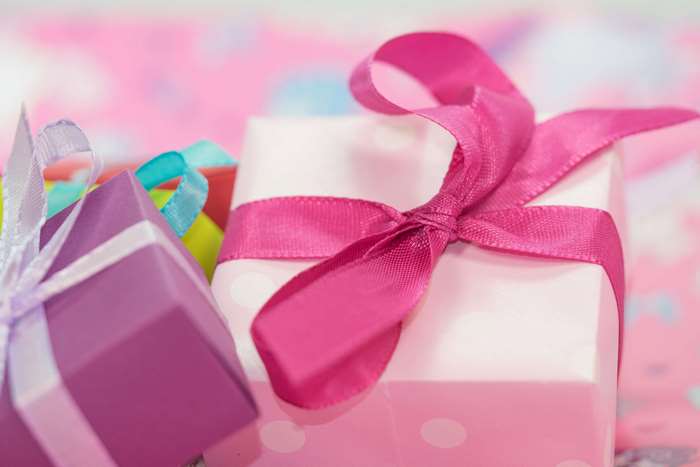Close up of pink and purple gift boxes with ribbons