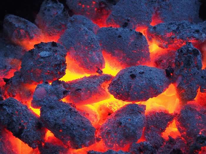 Close-up of glowing hot charcoal embers