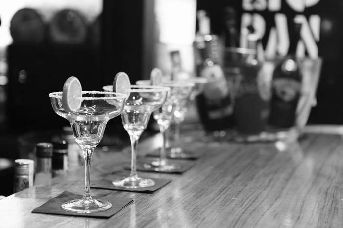 Margarita glasses with lime on a bar