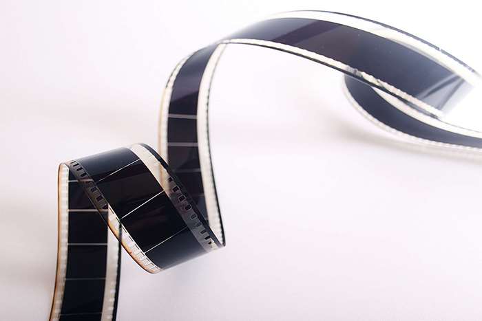 A curled filmstrip on a white background