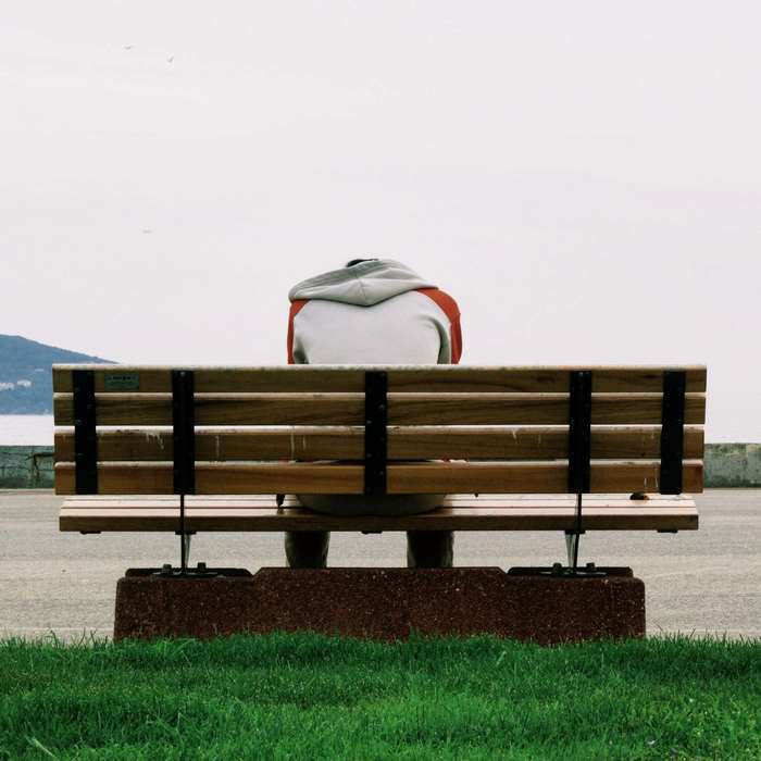 Person sitting alone on a park bench