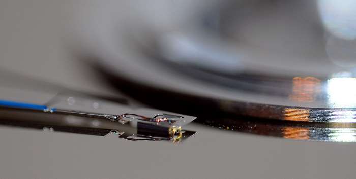 Close-up of a hard drive read/write head over a platter