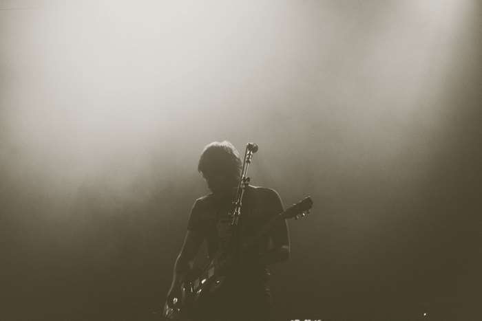 Musician playing guitar on stage