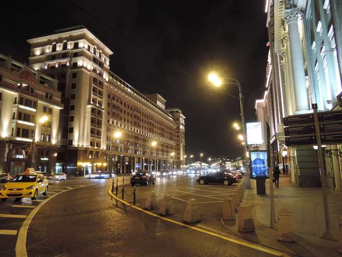 Moscow city street at night with cars and buildings