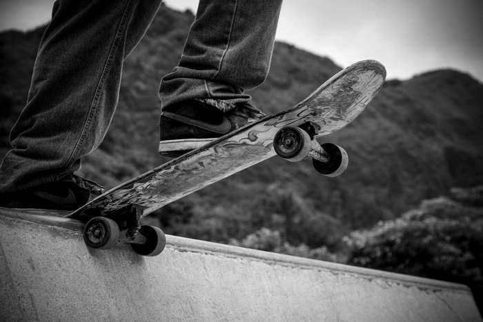Skateboarder on a ramp with mountains in the background