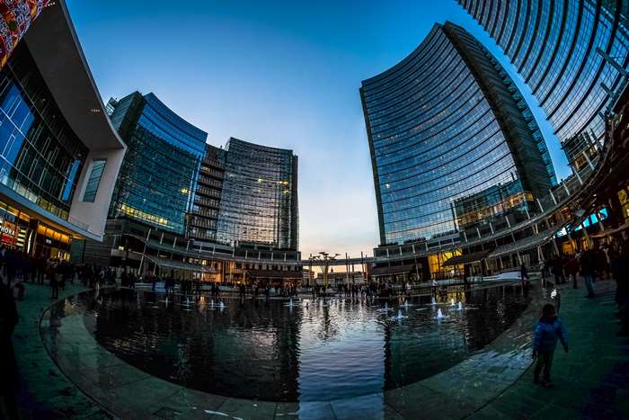 Modern city buildings with fountain and reflections