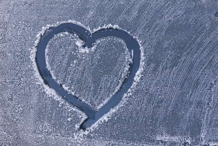 Heart drawn in frost on a car window