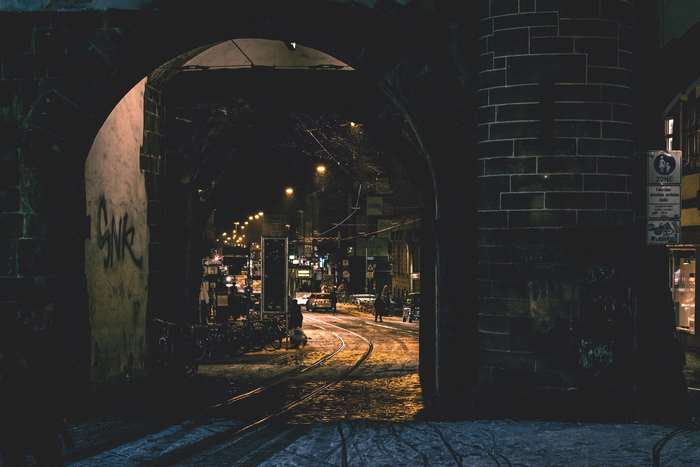 Night view through an archway in a historic European city