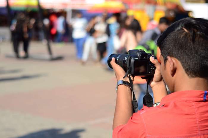 Man taking a photo with a DSLR camera