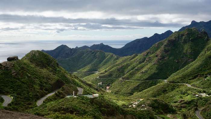 Road winding through green mountains in Tenerife, Canary Islands