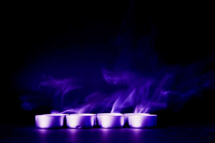 Purple smoke and flames from tea lights