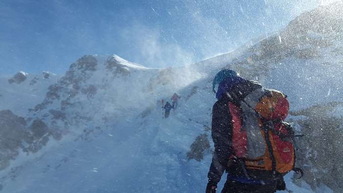 Mountaineers in a blizzard on a snowy mountain