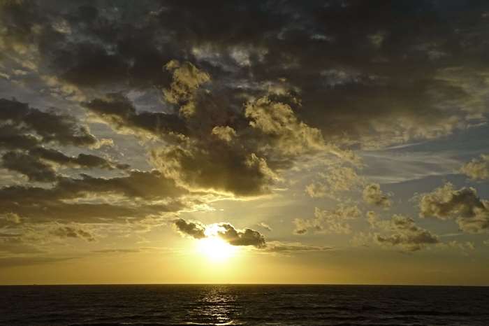 Sunset over the sea with dramatic clouds