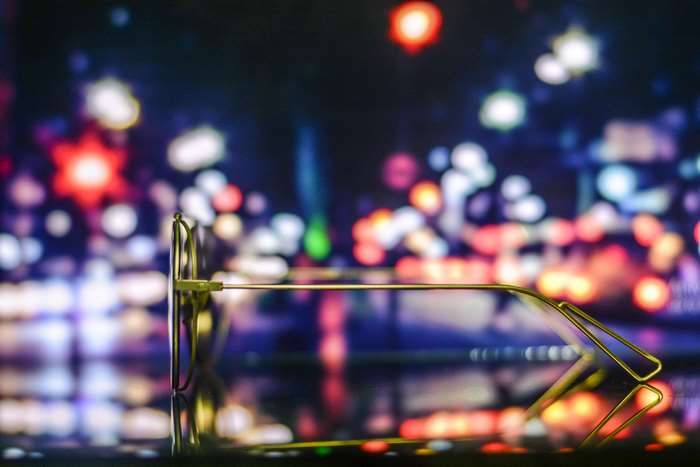Golden eyeglasses reflecting city lights at night