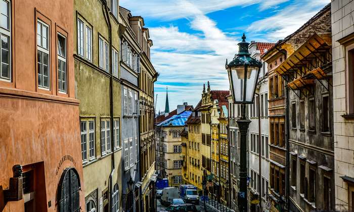 Narrow European street with colorful buildings and a street lamp