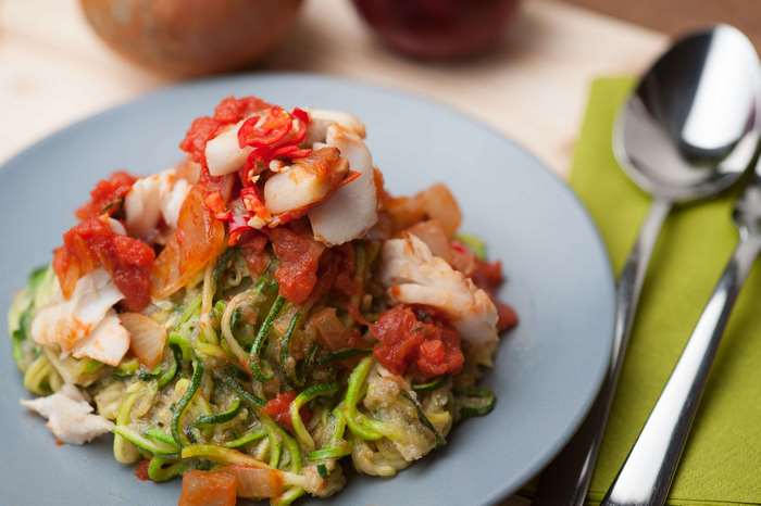 Healthy seafood pasta with tomato and chili on a plate
