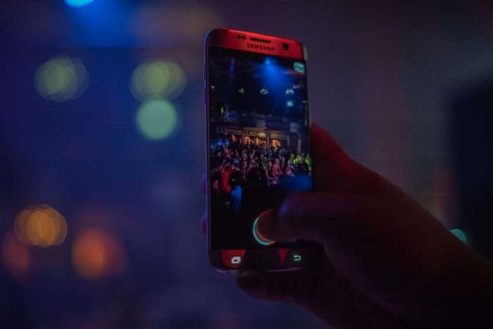 Samsung phone recording a crowded nightlife scene