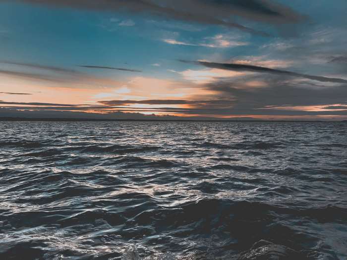 Ocean waves at sunset with colorful sky