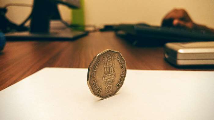 Indian 2 Rupee coin on a desk