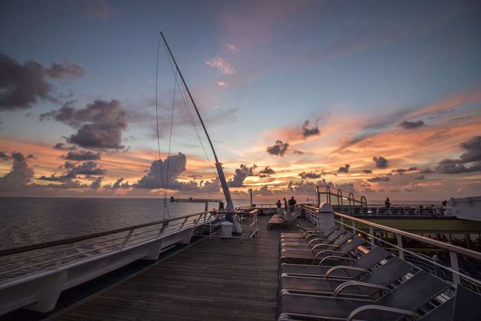 Cruise ship deck at sunset over the ocean