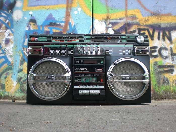 Retro boombox with cassette player on a graffiti wall background