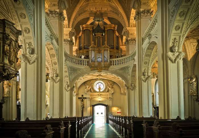 Interior of a Baroque church with an organ and pews