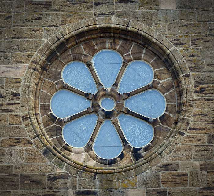Rose window on a stone wall