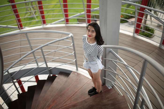 Young woman posing on a spiral staircase