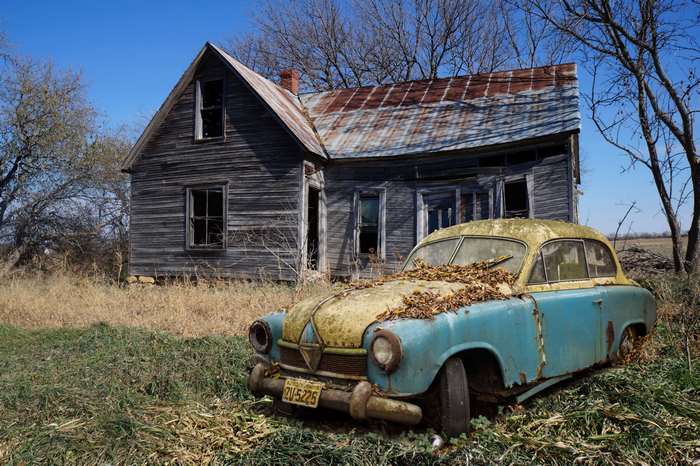 Rusty Borgward Hansa by Abandoned Wooden House