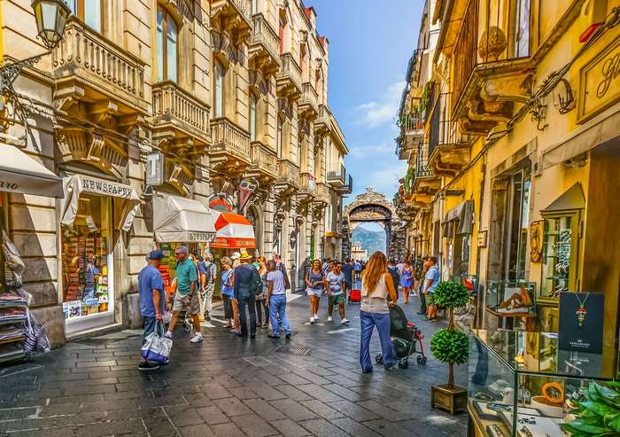 Street scene in Taormina, Sicily with shops and tourists