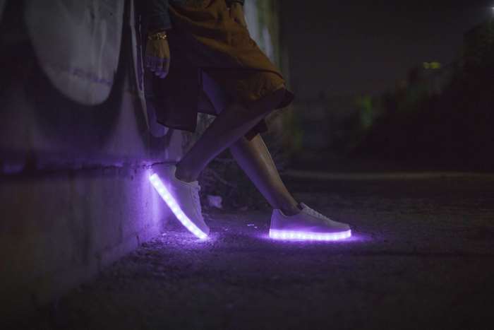 Person wearing light-up sneakers at night