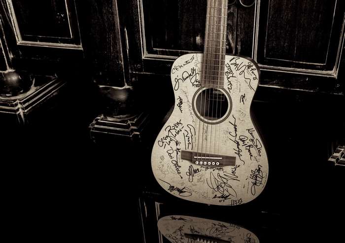 Acoustic guitar covered in signatures